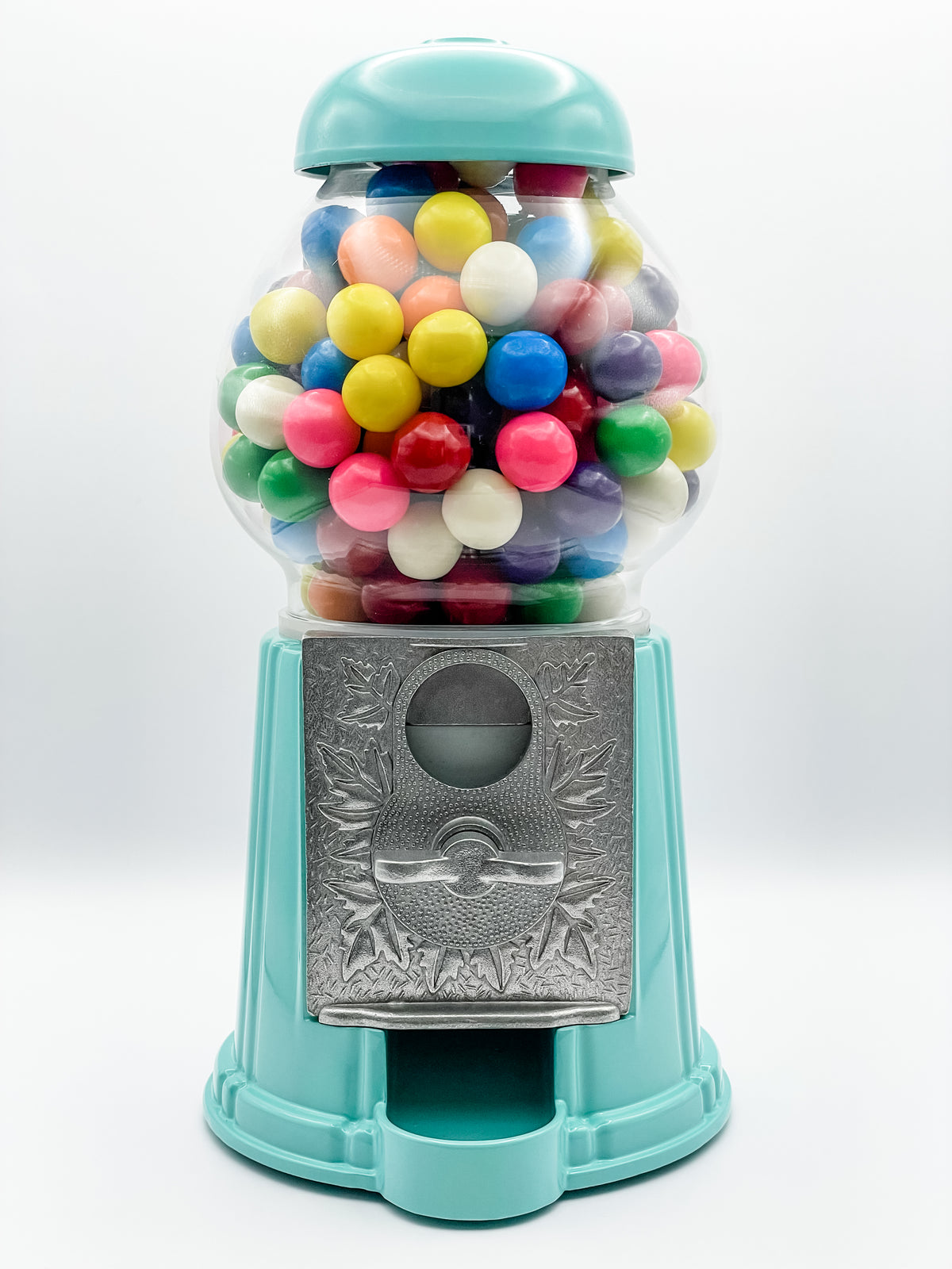 A seafoam green gumball machine with a metal base and a glass globe filled with multicolored gumballs, featuring a coin mechanism.
